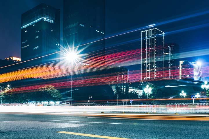 road in busy city with many neon lights