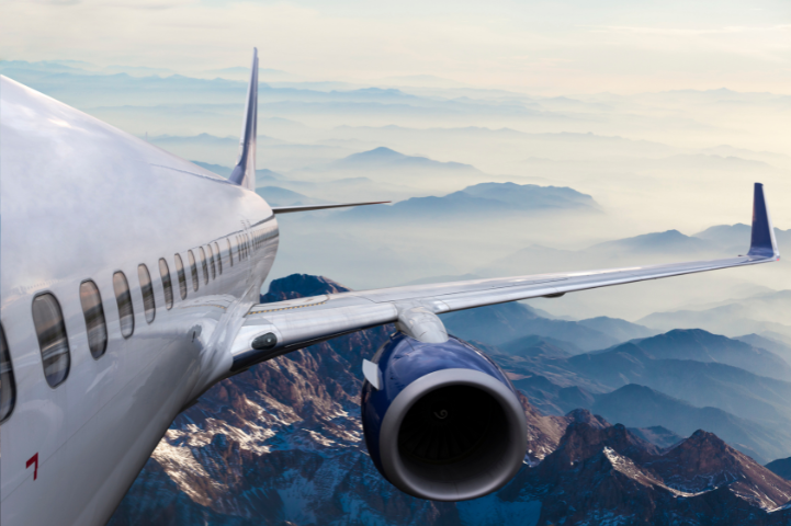 airplane in flight over mountain